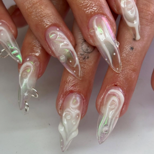 ongles pointus transparents et blancs avec des bagues et des vagues en relief